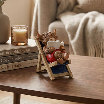Highland Cow Sitting Deck Chair Reading Ornament